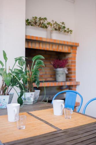 a wooden table with two chairs and a fireplace at Lousã Varandas House in Lousã