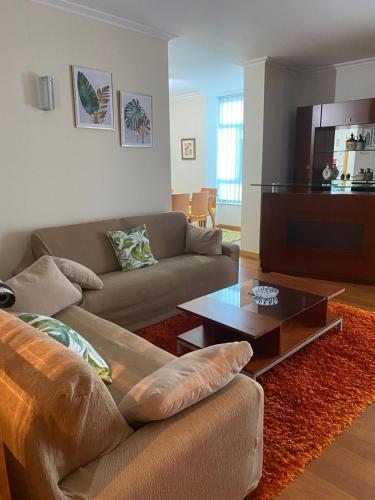 a living room with a couch and a coffee table at Cantinho da Paula in Monção