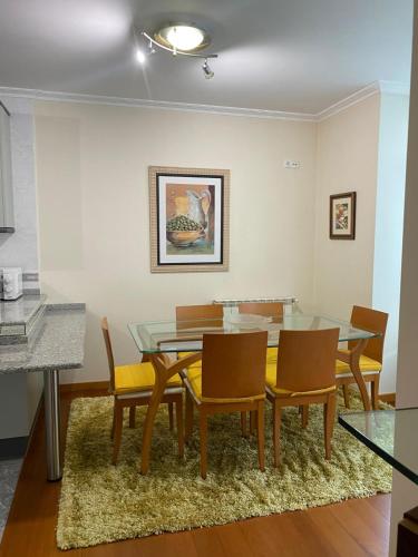 a dining room with a glass table and chairs at Cantinho da Paula in Monção