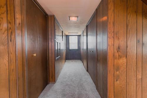 a hallway with wood paneled walls and a long corridor at 3 bedrooms at Cleveland in Euclid