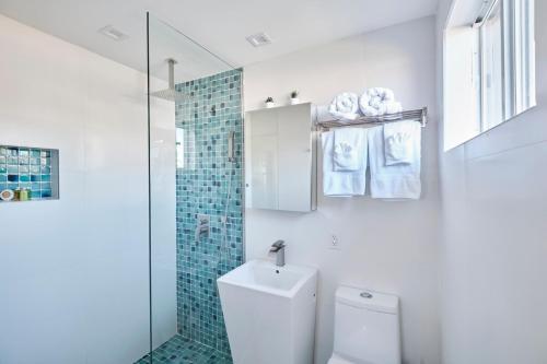 a white bathroom with a toilet and a shower at Waterfront Cabana 5 Key Largo in Key Largo