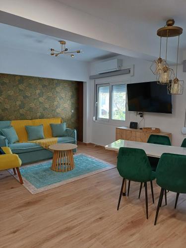 a living room with a couch and a table at Urban Garden Suite-Samos Center in Samos
