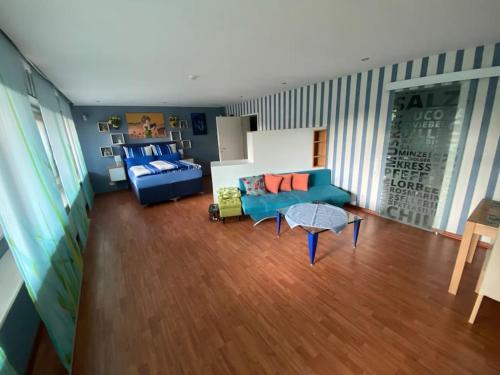 a living room with a blue couch and a table at Ilonas Home in Baden-Baden