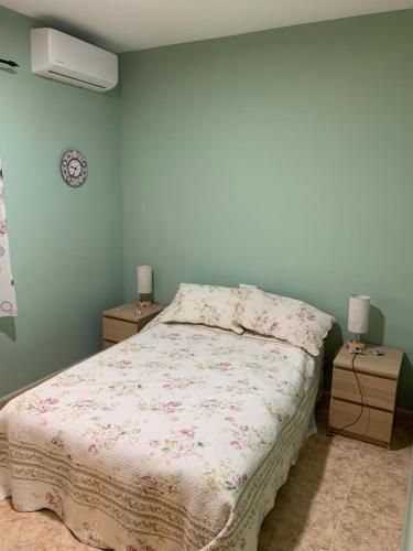 a bedroom with a bed and two night stands at Cortijo Estrella in Serón