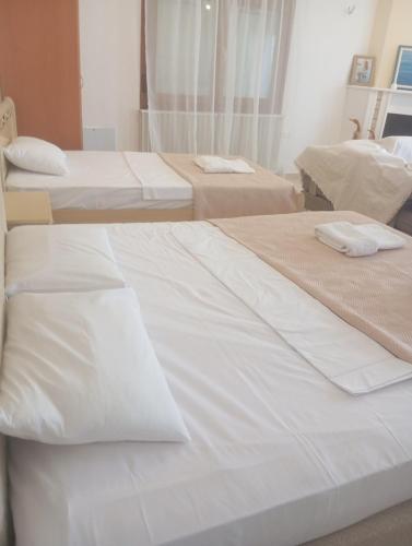 a group of three beds in a room at Sweet Home in Platamonas