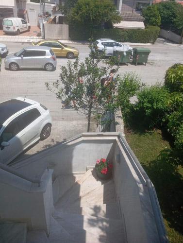 a car parked in a parking lot with a tree at Sweet Home in Platamonas