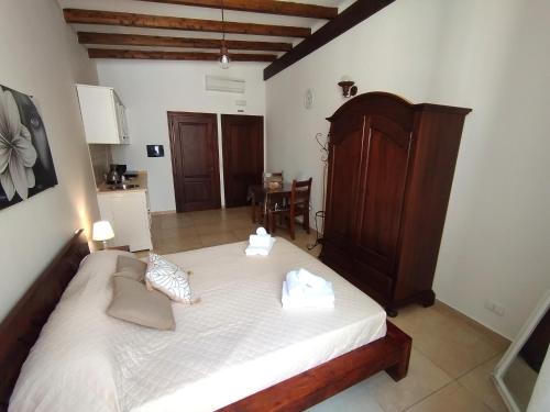 a bedroom with a large white bed with two pillows at Il Moro di Ossuna in Trapani