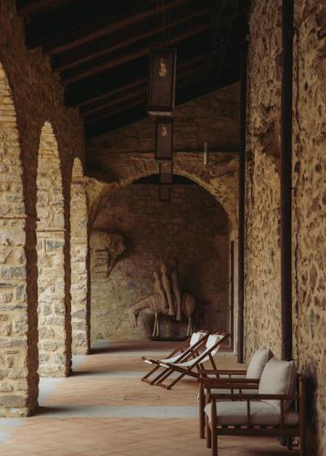 a room with a stone wall with a sculpture on the wall at Convento Francescano Experience Hotel Cilento in Cuccaro Vetere