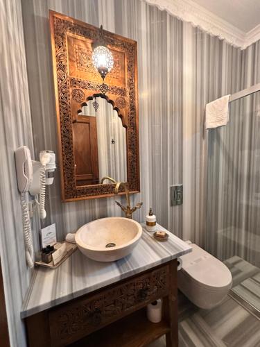 a bathroom with a sink and a mirror at Villa Ephesus Hotel in Kusadası