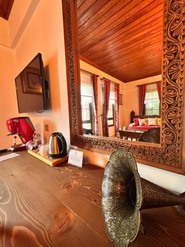 a room with a mirror and a bed with a fan at Villa Ephesus Hotel in Kusadası