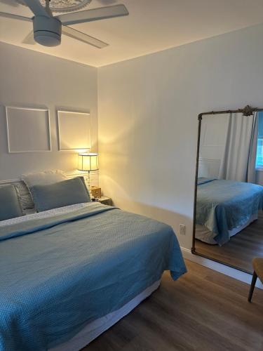 a bedroom with a bed and a mirror at The Most Desired Summer Retreat with Private Pool Just 5 Minutes from the Beach in Spring Lake