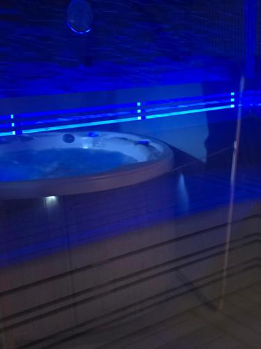 a bathroom with a white sink with blue lights at Karolingerweg in Lauterhofen