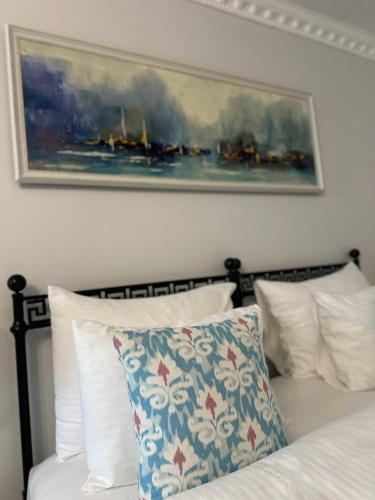 a bedroom with a bed with a painting on the wall at Villa Ephesus Hotel in Kusadası