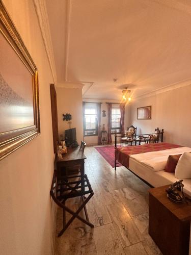 a bedroom with a bed and a desk in a room at Villa Ephesus Hotel in Kusadası