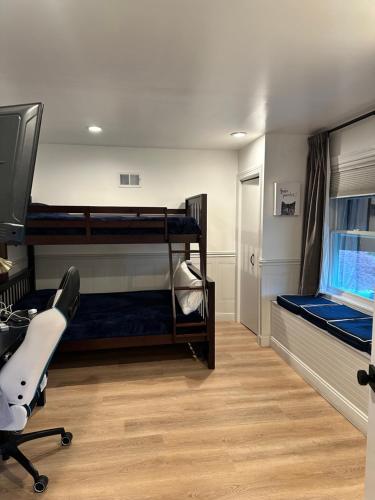 a room with two bunk beds and a desk at The Most Desired Summer Retreat with Private Pool Just 5 Minutes from the Beach in Spring Lake