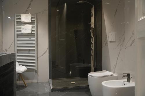 a bathroom with a shower and a toilet and a sink at Maison Canopée in Messina