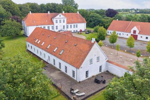 an aerial view of a large white building with red roofs at The Farm Managers House at Hindemae Estate Historic Charmed house in Ullerslev