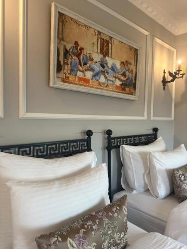 a bedroom with two beds and a painting on the wall at Villa Ephesus Hotel in Kusadası