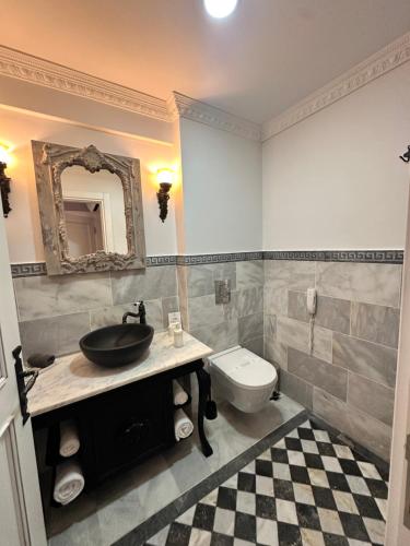 a bathroom with a sink and a toilet at Villa Ephesus Hotel in Kusadası