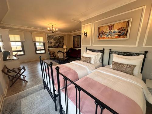 a bedroom with two beds and a living room at Villa Ephesus Hotel in Kusadası