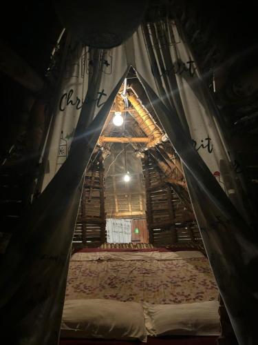 a room with a bed inside of a tent at Bamboo hutz in Jāmb