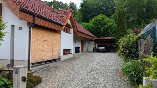 a house with a car parked in a driveway at SIMA - RELAX, Žilina in Žilina