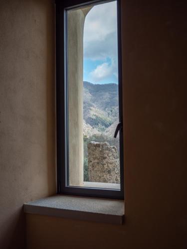 a window with a view of a mountain view at Convento Francescano Experience Hotel Cilento in Cuccaro Vetere