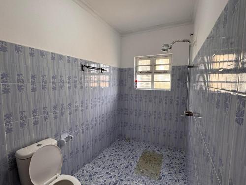 a bathroom with a toilet and a shower at Naivasha Vacation Homes - Villaview in Naivasha