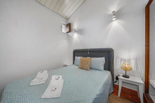 a bedroom with a bed with two trays on it at Sea Hut Apulia in Apúlia
