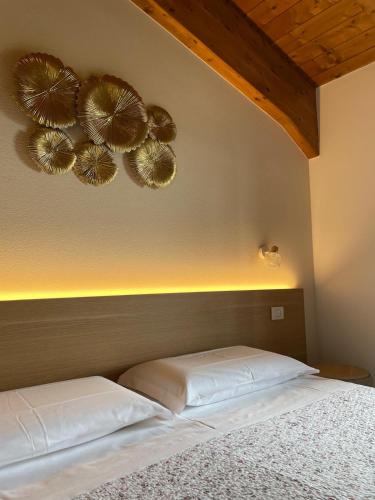 a bed with two white pillows in a bedroom at Agriturismo La Rondinella in Dozza