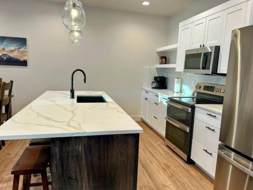 a kitchen with a sink and a counter top at Teton Duo | Side-by-Side Homes | Hot Tubs+Walkable in Driggs