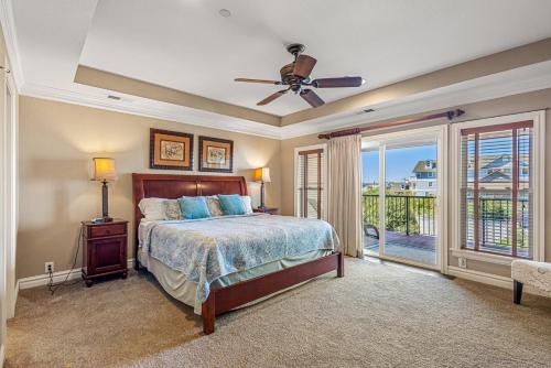 a bedroom with a bed and a ceiling fan at CSC3S - Drive In in Kill Devil Hills