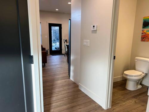 a bathroom with a toilet and a hallway at Teton Duo | Side-by-Side Homes | Hot Tubs+Walkable in Driggs