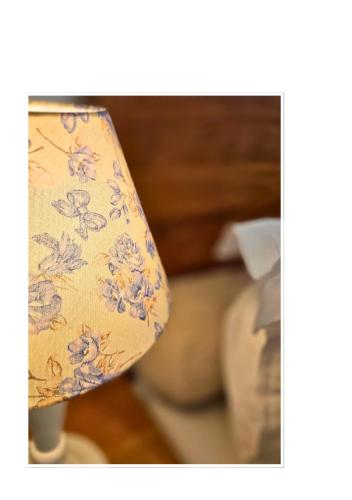 a close up of a lampshade with flowers on it at Jardim Secreto - Itaipava in Itaipava