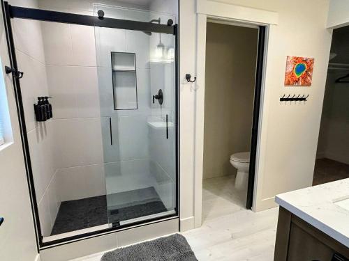 a glass shower in a bathroom with a toilet at Teton Duo | Side-by-Side Homes | Hot Tubs+Walkable in Driggs