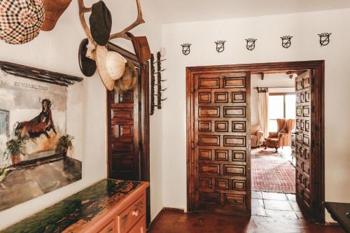 a hallway with a wooden door and a room at Dehesa de la yeguas-Finca privada con piscina a 15 min playas in Cádiz