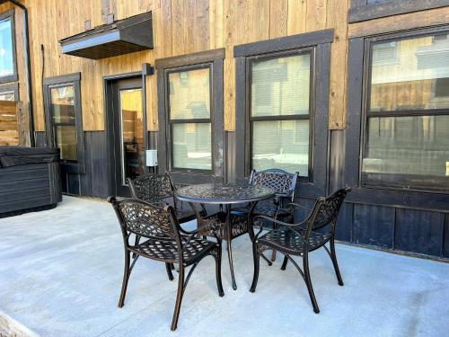 a table and chairs sitting on a patio at Teton Duo | Side-by-Side Homes | Hot Tubs+Walkable in Driggs