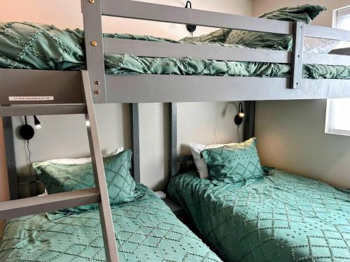 a bedroom with two bunk beds and a bed at Teton Duo | Side-by-Side Homes | Hot Tubs+Walkable in Driggs