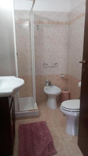 a bathroom with a shower and a toilet and a sink at Casa del Sole in Sasso