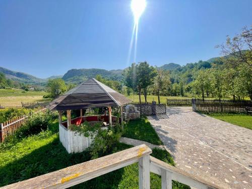 a gazebo in a park with a fence at Stani i Metes-Bujtina Sebisht in Sebisht