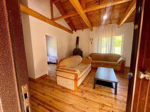 a living room with a couch and a table at Stani i Metes-Bujtina Sebisht in Sebisht