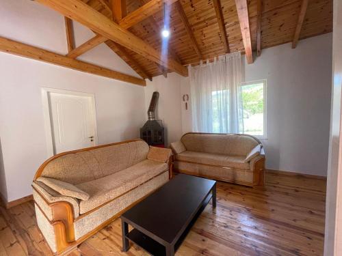 a living room with a couch and a coffee table at Stani i Metes-Bujtina Sebisht in Sebisht