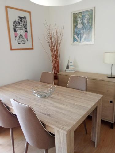 a dining room table with chairs and a table at Apartamento Abibinho in Figueira da Foz