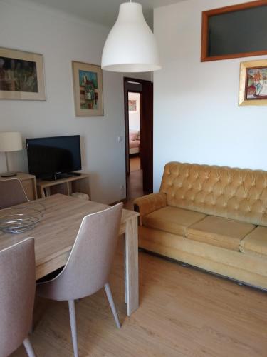 a living room with a couch and a table at Apartamento Abibinho in Figueira da Foz