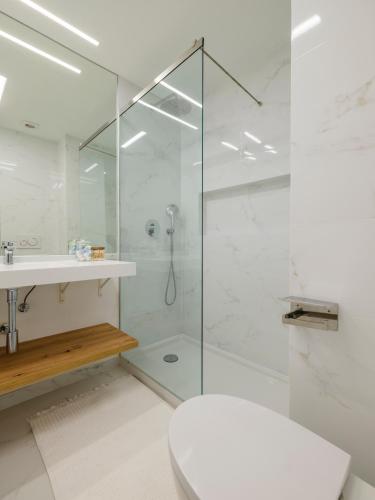 a bathroom with a glass shower and a toilet at Olivais Spacious Apartment near airport in Lisbon