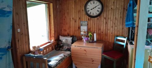 a room with a clock on a wooden wall at Landvetter in Landvetter
