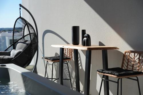 a table and two chairs on a balcony at Artion Suites Nikiti in Nikiti
