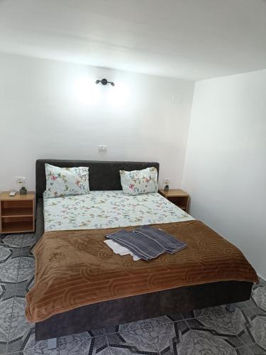 a bedroom with a large bed with two pillows at Vila Andra in Costinesti