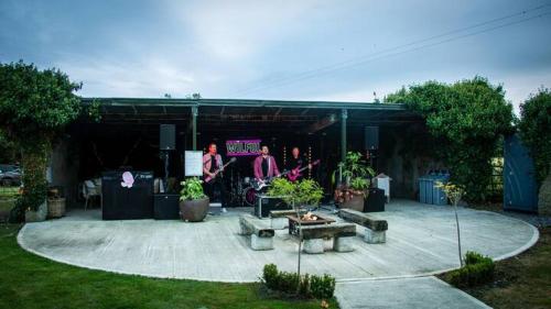 a group of people standing in a garage at Fitz Of Inch in Stradbally