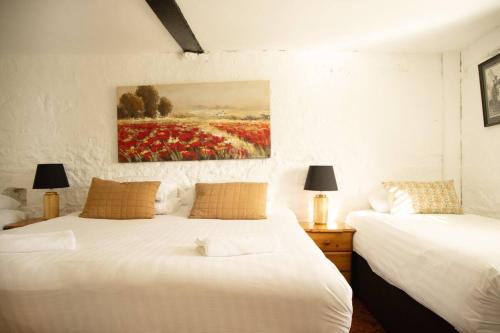 a bedroom with two beds and a painting on the wall at Fitz Of Inch in Stradbally